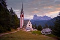 Church of St. JacobÃ¢â¬â¢s, Church of San GiacomoÃ¢â¬â¢s next to the town of Ortisei in the background with the mountains of the Royalty Free Stock Photo